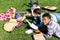 group of multiethnic teen scholars lying on grass