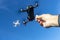 A Group Of Multiple Drones Fly Together Through The Air Against A Blue Sky Waiting To Be Fed