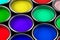 Group of multiple paint buckets filled with red, green, blue and yellow paint, home renovation or color concept