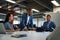 Group of multiracial business people in businesswear smiling and gesturing during meeting in office