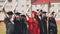 group of multiracial graduates holding diploma.