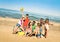 Group of multiracial happy friends having fun with beach games