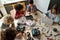 Group of multiracial schoolkids at stem class building robot. Table top view.