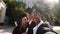 Group of multiracial students graduates two ladies and one guy taking selfie video with the camera smiling large after