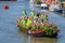 Group of musicians in green shirts on a beautiful boat decorated