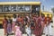 Group of Native American girls in costume standing in front of school bus in Mexican Hat, southern UT