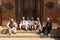 Group of Nepalese men on a wooden bench discussing news of today