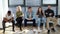 Group of nervous diverse ethnicity candidates waiting job interview in modern office lobby.