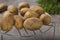 Group of new potatoes on a metallic grille