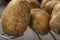 Group of new potatoes on a metallic grille