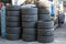 Group of new tires for race car. New tires for sale at a tire store. Car tires in the warehouse.