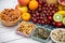 Group Nuts dry put on the bowl and fruit is banana,pineapple and grape is food healthy on the wooden table background