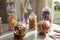 A group of old fashioned glass jars of delicious sweets, with party decorations in the background