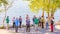 a group of older people studying Scandinavian walking on the Volga River Embankment on a summer sunny day