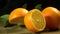 Group of oranges with leaves on wooden boards.