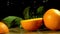 Group of oranges with leaves on wooden boards.