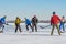 Group of ordinary people playing hockey on a frozen river Dnipro in Ukraine