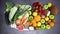Group of organic and fresh fruits and vegetables moving on dark background - Stop motion