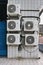 Group of outer air conditioners on wall of residential building. Maintenance house facilities.Climate technology.