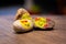 A group of painted pebbles with emoji faces on a table