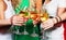Group of partying girls clinking flutes with sparkling wine