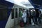 Group of passengers standing in front of doors of the passenger train to enter the wagon