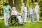 Group of patients with caregiver in the garden of nursing home