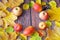 Group Pears and apples with autumn leaves on wooden background, closeup, top view, autumn harvest concept