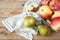 Group Pears and apples with napkin on wooden background, closeup, top view, autumn harvest concept