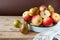 Group Pears and apples with napkin on wooden background, closeup, top view, autumn harvest concept