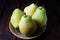 Group of pears on a dark wooden background.