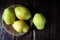 Group of pears on a dark wooden background.