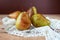 Group Pears  with napkin on wooden background, closeup, top view, autumn harvest concept