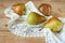 Group Pears  with napkin on wooden background, closeup, top view, autumn harvest concept