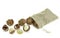 Group peeled and unpeeled macadamia nuts in sack bag at white background