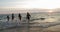 Group Of People On Beach At Sunset Running In Sea Making Splashes Mix Race Cheerful Friends On Vacation