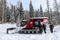 A group of people boarding a red snowcat on the way to the beautiful Island lake Lodge outside of Fernie, British Columbia, Canada