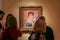 A group of people are considering the picture of Renoir `Portrait of the Actress Jeanne Samary` in the art gallery of the Pushkin