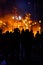 Group of people contemplating how a cardboard monument burns in Valencian Fallas