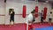 Group of people of different ages training in the boxing hall