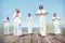 Group of People Doing Yoga on Beach