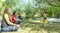 Group of people doing yoga exercise in the park, womans relaxing in the park