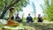 Group of people doing yoga exercise in the park, womans relaxing in the park