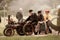 Group of people driving a vintage tractor down a rural road.