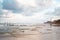 Group of people enjoying a leisurely stroll along the sandy beach