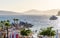 Group of people enjoying a sunny day on a beach, lounging in beach chairs near the shoreline