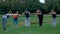 Group of people exercising yoga outdoor.