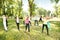 Group of people exercising yoga in park