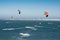 Group of people extreme action by jumping above the sea water with kitesurfing board in green color at Brighton le sands beach.