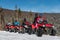 Group of people on four-wheelers ATV bikes on snow in winter